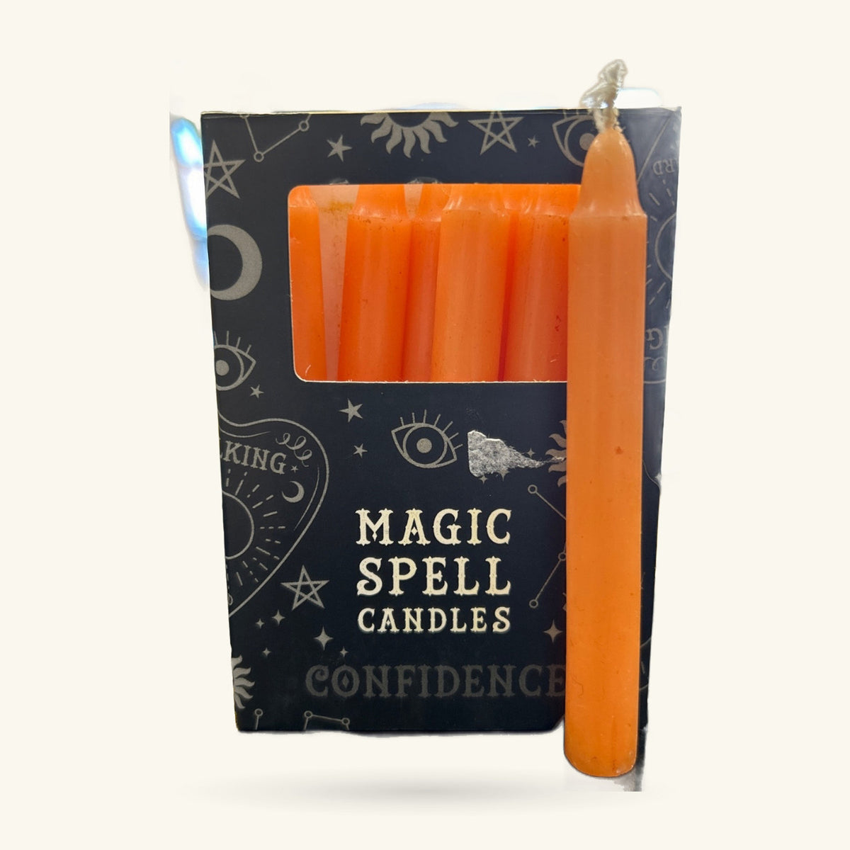 Box of orange Magic Spell Candles labeled Confidence, with six candles visible through window and one displayed