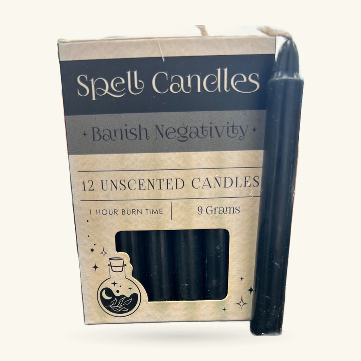 Box of 12 black unscented spell candles for banishing negativity, with one candle displayed beside it.
