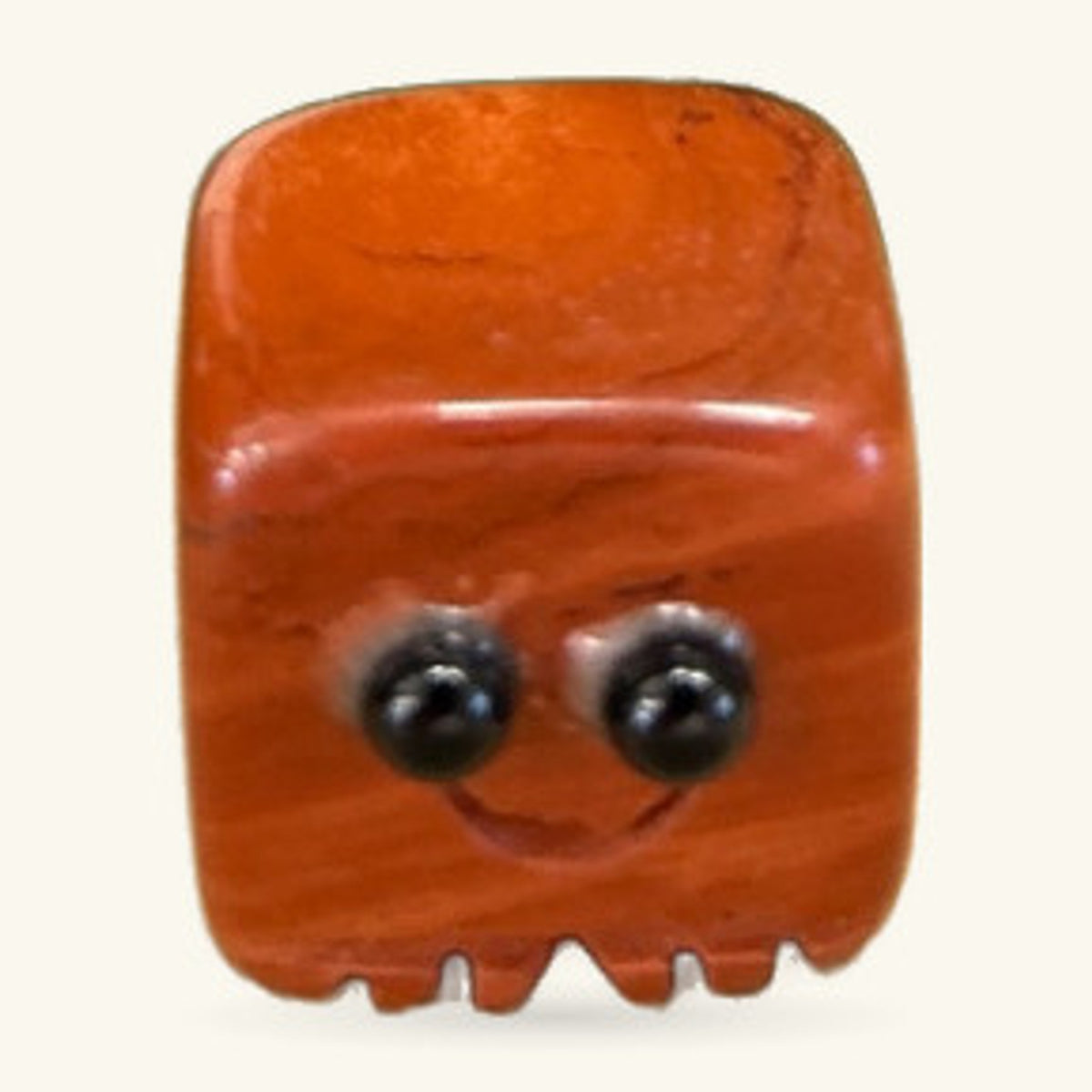 Red Jasper Block Buddy: a rounded orange-red polished stone figure with googly eyes and a flat base.