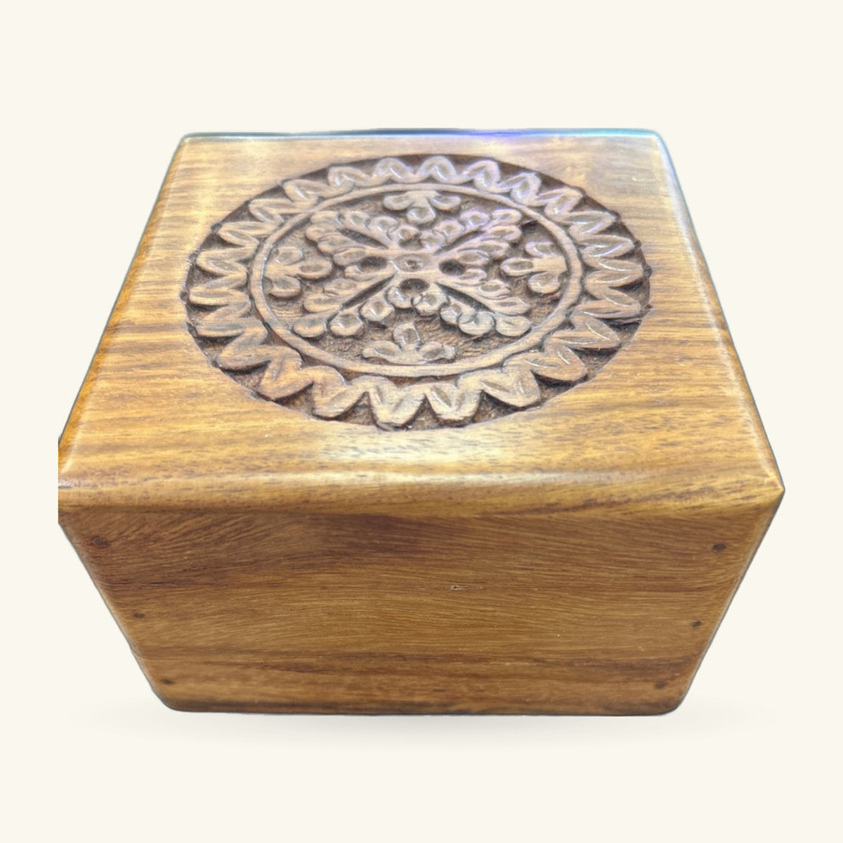 Wooden hexagonal box with carved circular floral medallion on top lid