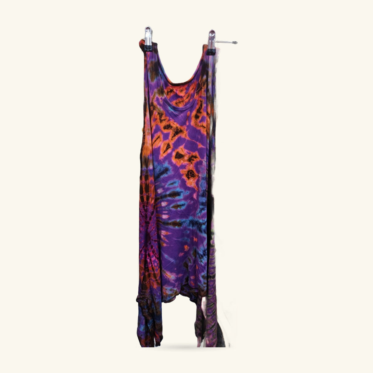 Tie dye yoga tank dress in purple, orange, and black, hanging on display with metal clasp closures