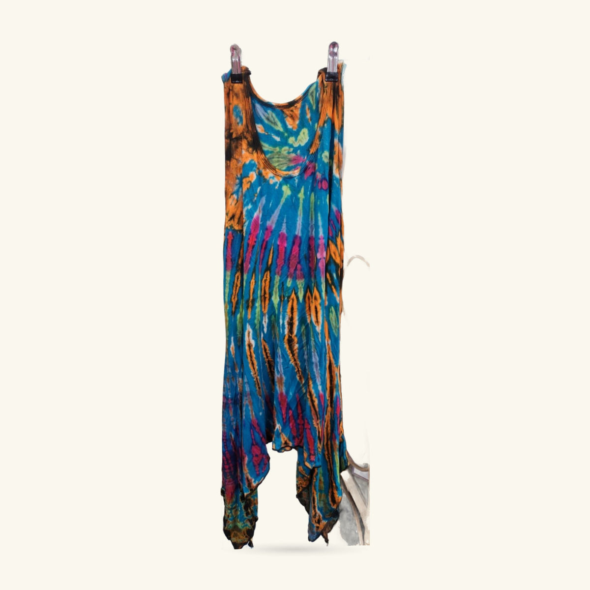 Tie dye yoga tank dress in blue, orange, pink and yellow, displayed on a stand