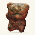 Red Sesame Jasper bear carving, polished, sitting upright against a neutral background
