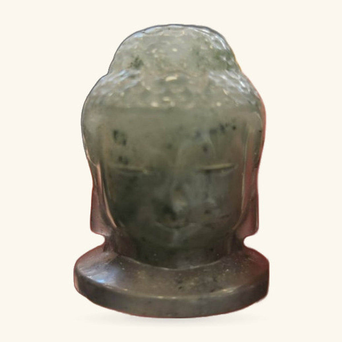 Labradorite Buddha head sculpture on a dark base, showing mottled green-grey stone with polished finish