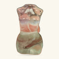 Fluorite body carving showing natural colour layering in cream, peach, and grey tones