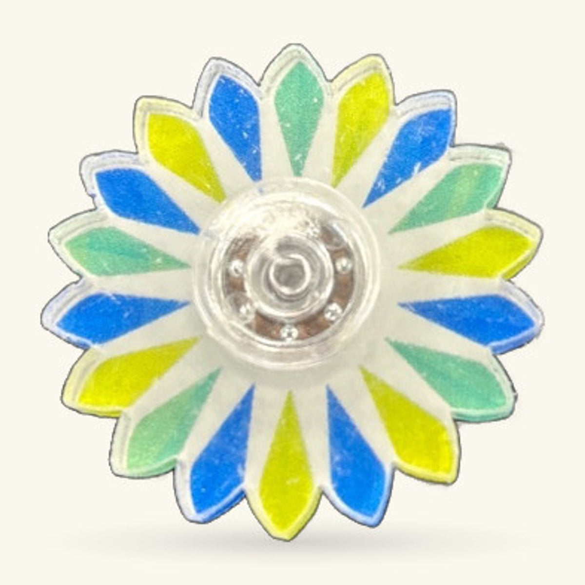 Blue, yellow, and green flower-shaped fidget spinner with white petals and silver centre.