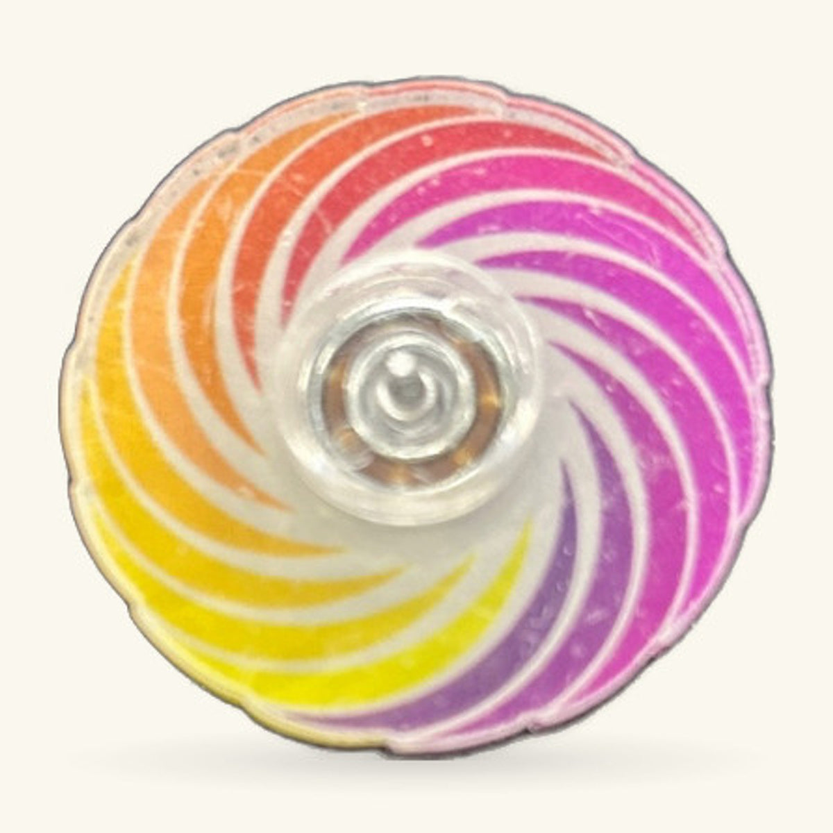 Rainbow fidget spinner with yellow, orange, red, pink and purple spiral stripes and clear centre cap
