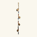 Vertical hanging strand with four gold-coloured iron bells separated by black and coloured glass beads on twine