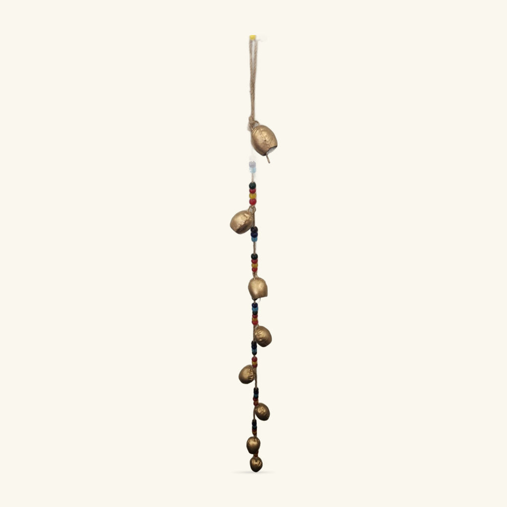 Gold-coloured iron bells with coloured glass beads on twine, hanging vertically