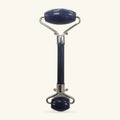 Lapis Lazuli facial massage roller with chrome handles and base, dark blue stone rollers top and bottom