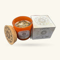 Orange candle with cork lid, gemstone wax, and white zodiac-printed box for Capricorn candle