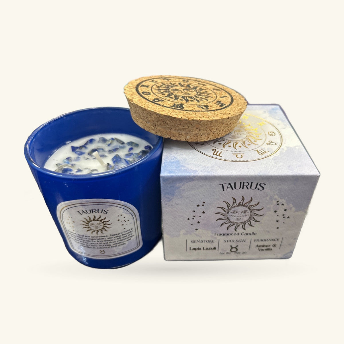 Taurus Amber and Vanilla candle in deep blue glass with cork lid and zodiac-printed box