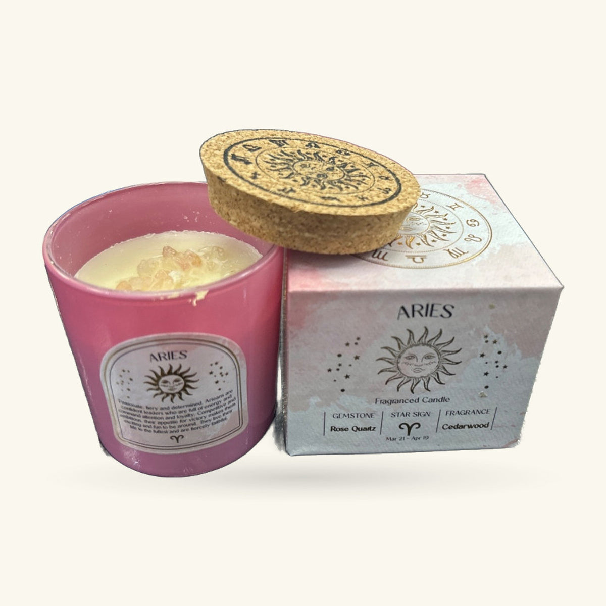 Pink Aries cedarwood candle in glass jar with gold cork lid and matching box featuring rose quartz gemstone detail