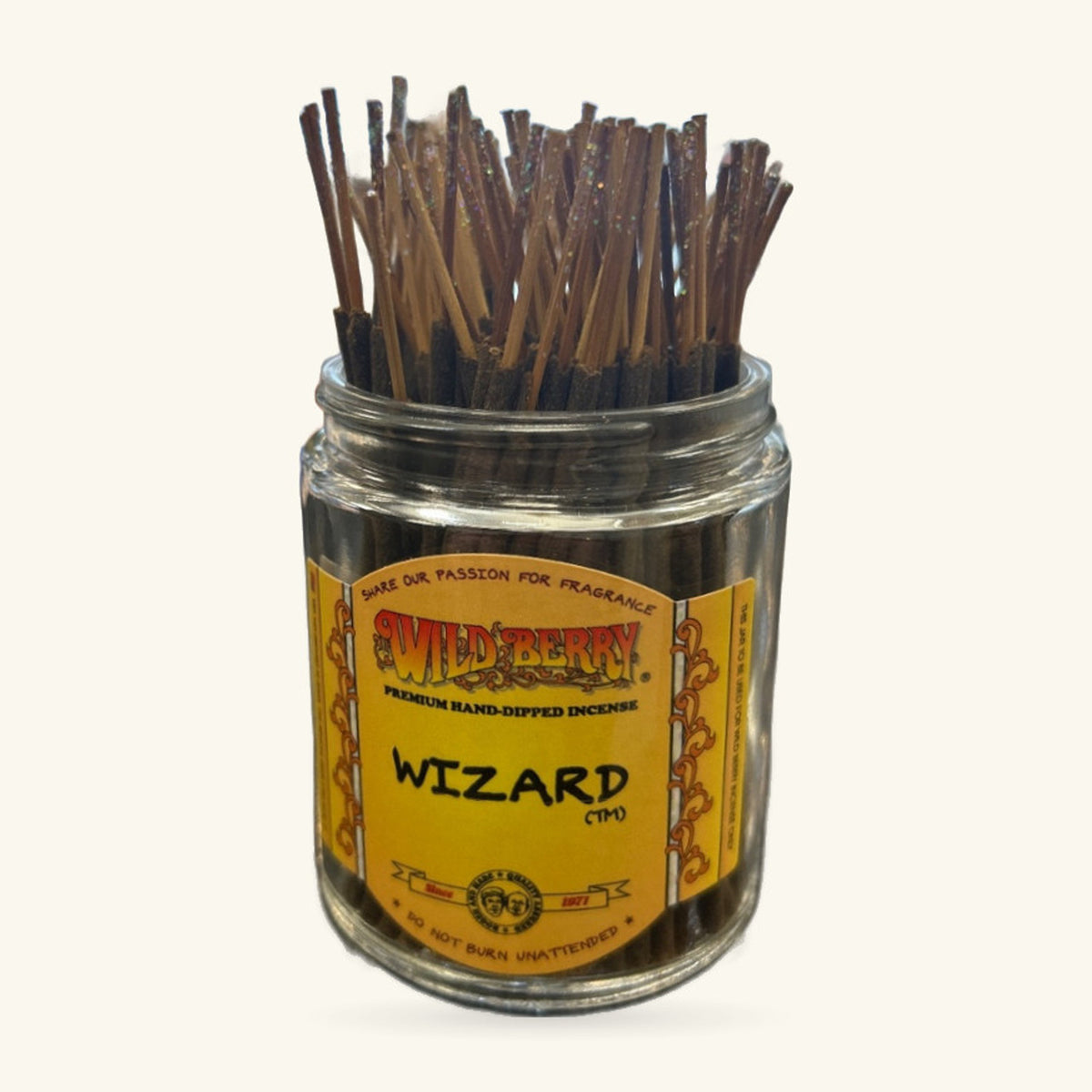 Jar of Wild Berry Wizard incense sticks with yellow label, dark hand-dipped sticks fanned upright