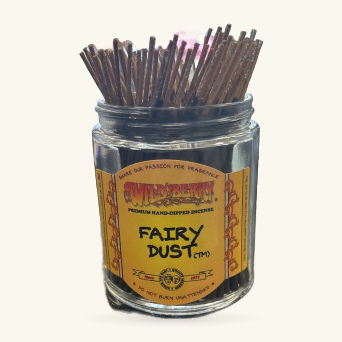 Glass jar of Wild Berry Fairy Dust incense sticks with brown wood tips and yellow label