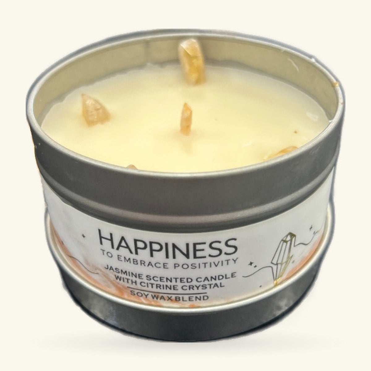 Cream soy wax candle in a tin with grey lid, three golden citrine crystals poking through the surface