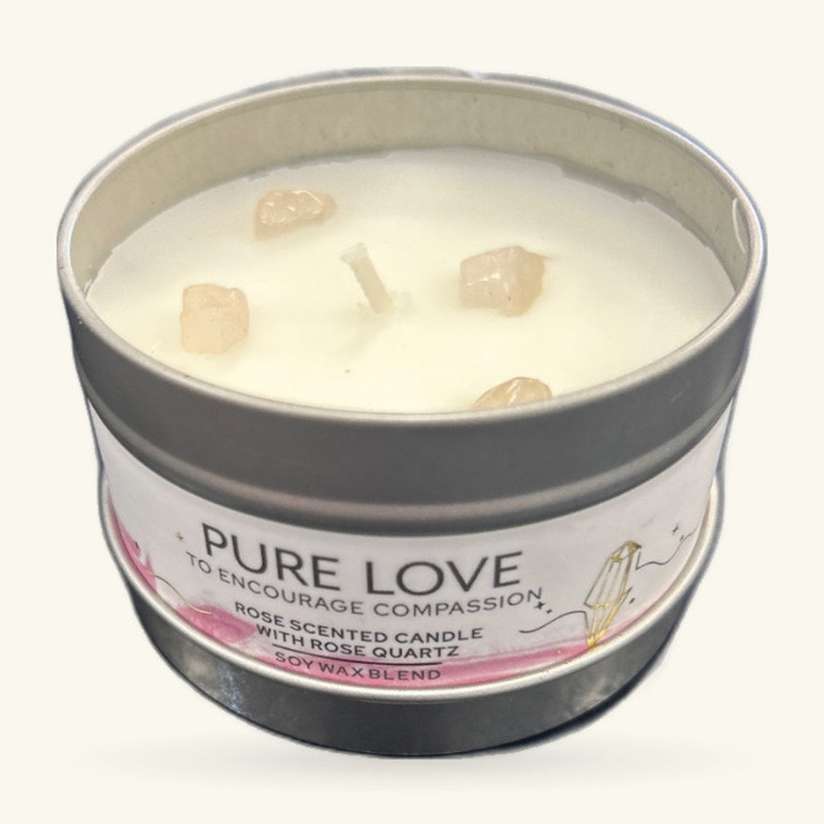 Cream soy wax candle in a tin with grey lid, embedded with pale rose quartz crystals and a wooden wick
