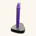Purple spell candle in a heart-shaped black holder engraved with a talking board design and silver trim.