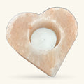 Heart-shaped Himalayan salt tea light holder with a white tea light nestled in the centre