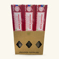 Three boxes of Satya Dragon's Blood Smudge Incense in burgundy packaging, displayed in kraft cardboard sleeve with diamond-shaped windows