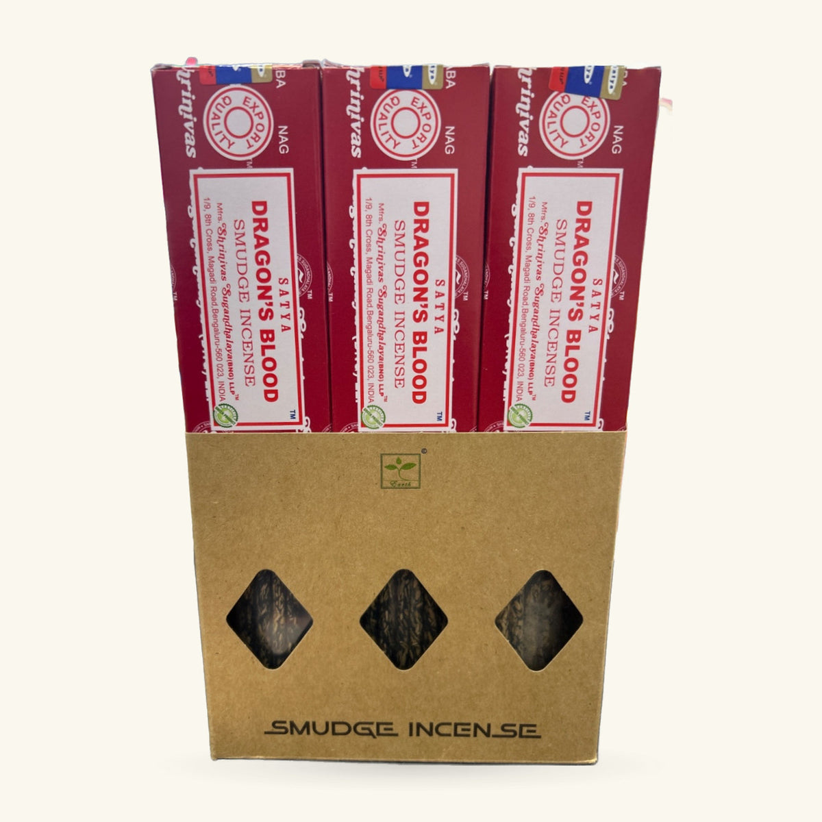 Three boxes of Satya Dragon's Blood Smudge Incense in burgundy packaging, displayed in kraft cardboard sleeve with diamond-shaped windows