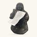 Black stone Hotei laughing Buddha statue, 20cm tall, holding a scroll with text