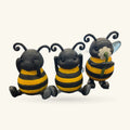Three black and yellow striped bee figurines with curled antennae, smiling faces, and different poses
