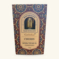 Goloka Cherry Natural Perfume Oil 12ml in ornate burgundy and blue packaging with a brass applicator cap visible through a circular window.