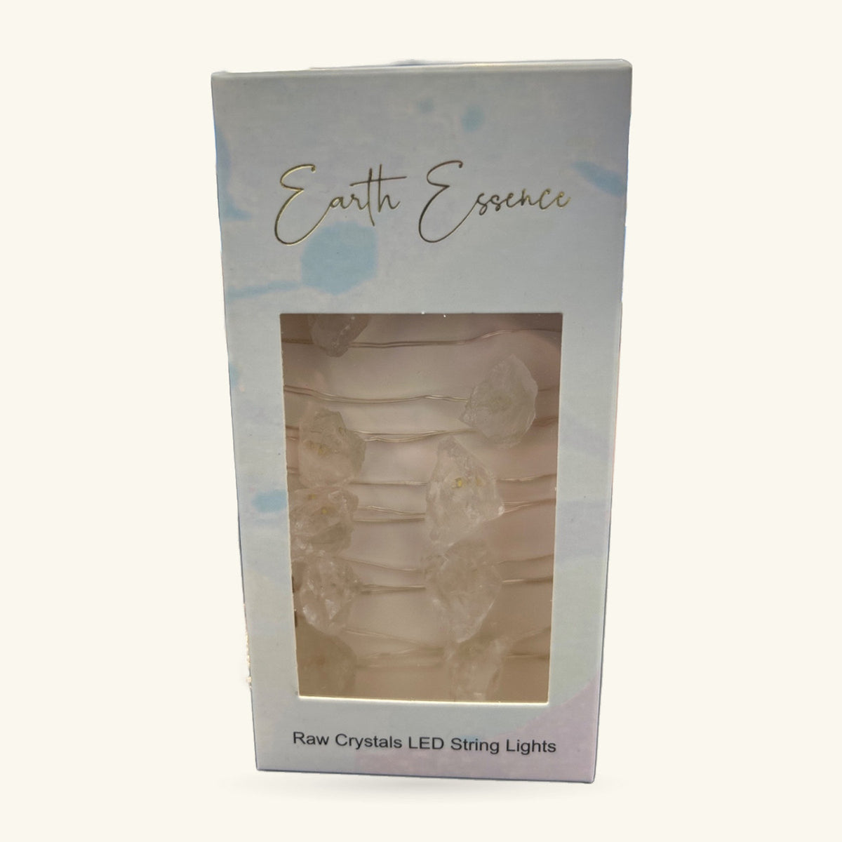 Earth Essence Raw Clear Quartz LED String Lights in white box with window showing cream-coloured raw quartz chunks on wire.
