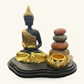 Buddha incense cone holder with gold-robed seated figure, stacked stone tower, and gold lotus-shaped dish on black base.