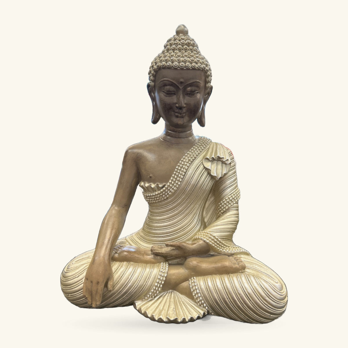 Seated Buddha statue in bronze and cream, 25cm tall, wearing draped robes with beaded details.